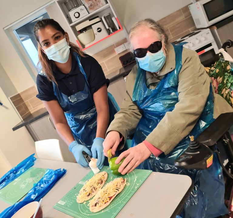 A service user learning to cook with sight loss